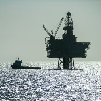 Offshore platform and vessel at sea.