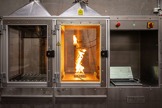 Mini-SBI test equipment with flame during small-scale fire testing in DBI’s laboratory.