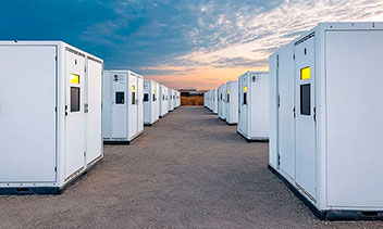 Battery energy storage containers at a maritime site, illustrating fire engineering and consulting for vessels, offshore installations and port infrastructure.