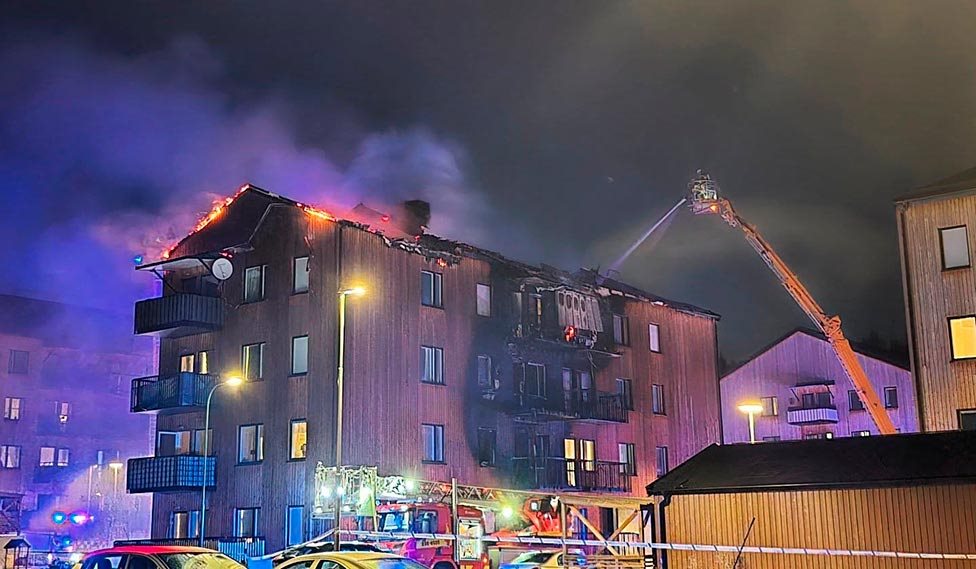 Firefighters tackling a facade fire in a timber-clad apartment building in Upplands-Bro, Sweden.